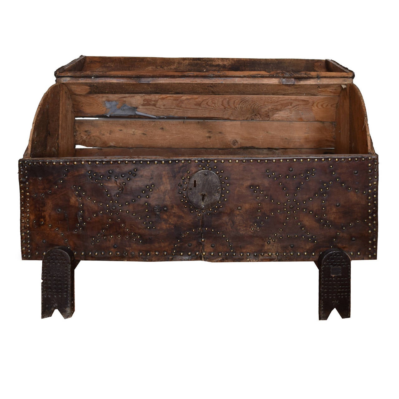 An unbelievable 18th century French trunk on stand with arched top, covered in a perfectly patinated leather with an unusual brass studded Maltese cross pattern, with an iron lock and latch.