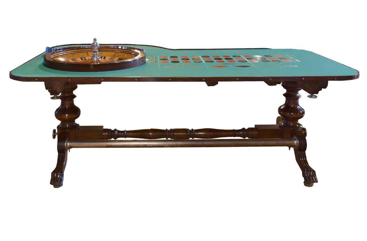 An H.C Evans & Co. roulette outfit, c. 1935, with felt topped mahogany table, regulation wheel, playing cards, chips, dice and dice boxes, three regulation roulette balls, three Austrian bentwood players chairs and one dealer chair, and locking