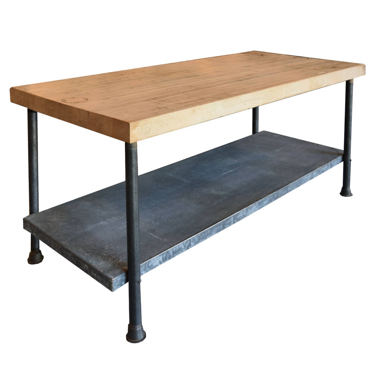 Vintage American industrial work table with butcher block top, galvanized steel shelf, and iron legs.