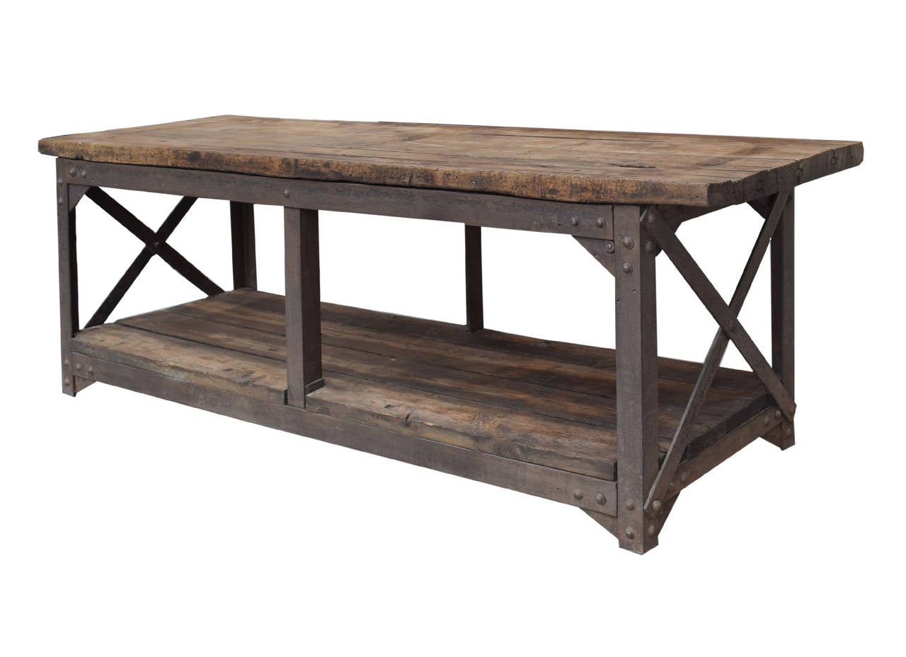 Early 20th century Industrial table with a metal base, low wood plank shelf, and a wood plank top from Bethlehem steel in Bethlehem, PA.