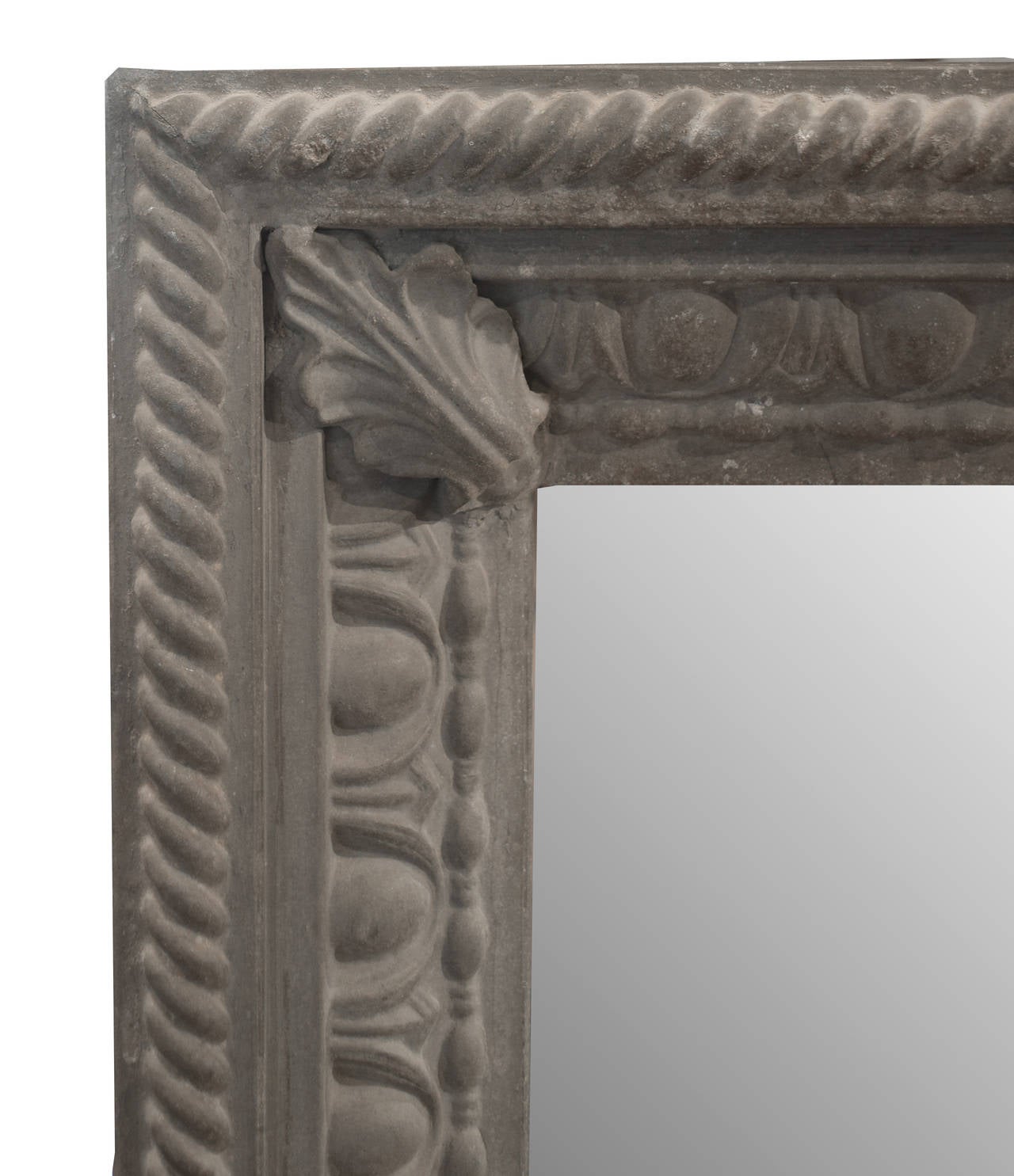 An Argentine pressed zinc mirror with an egg and dart motif with acanthus leaf corners within a rope pattern border, circa 1900.
  