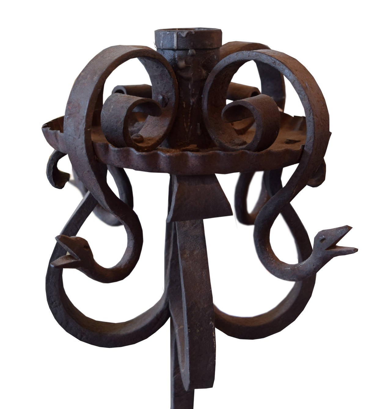 A terrific wrought iron candle stand with four legs and four scrolling serpents from the estate of Jose Thenee in Argentina. Thenee was considered the greatest blacksmith in the world in the 1920s-1930s.