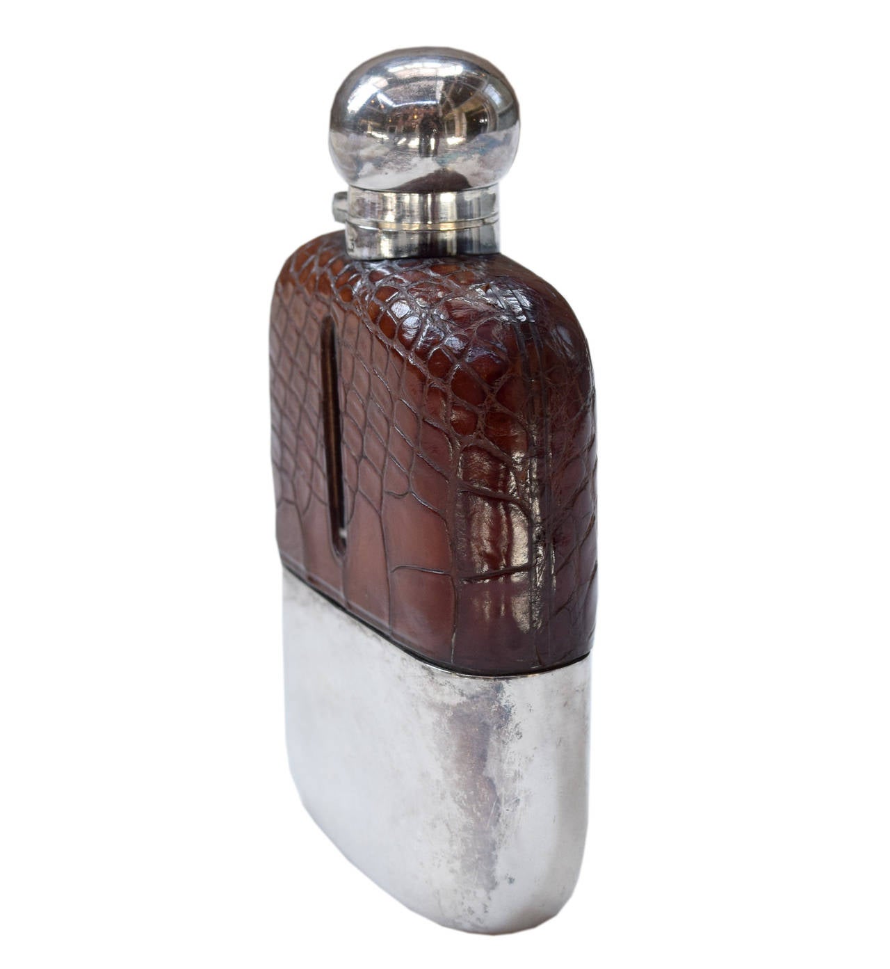 An early 20th century alligator and silver plate flask by James Dixon and Sons, London. The flask features a removable gold lined cup and a bayonet style cap. Engraved on the front with a W, I and S.