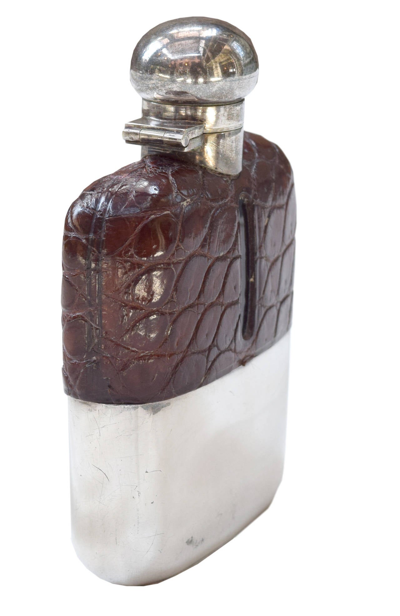 A stamped leather and silver hip flask with a removable drinking cup and bayonet style cap, from Henry A Murton, New Castle on Tyne, circa 1894.