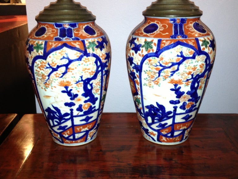 This pair of Japanese IMARI VASES were made into LAMPS with the wire coming out of the top (NOT DRILLED) if removed are a stunning pair of VASES with the hand painted cobalt blue and iron red with green colors in a design of flowers and trees. The