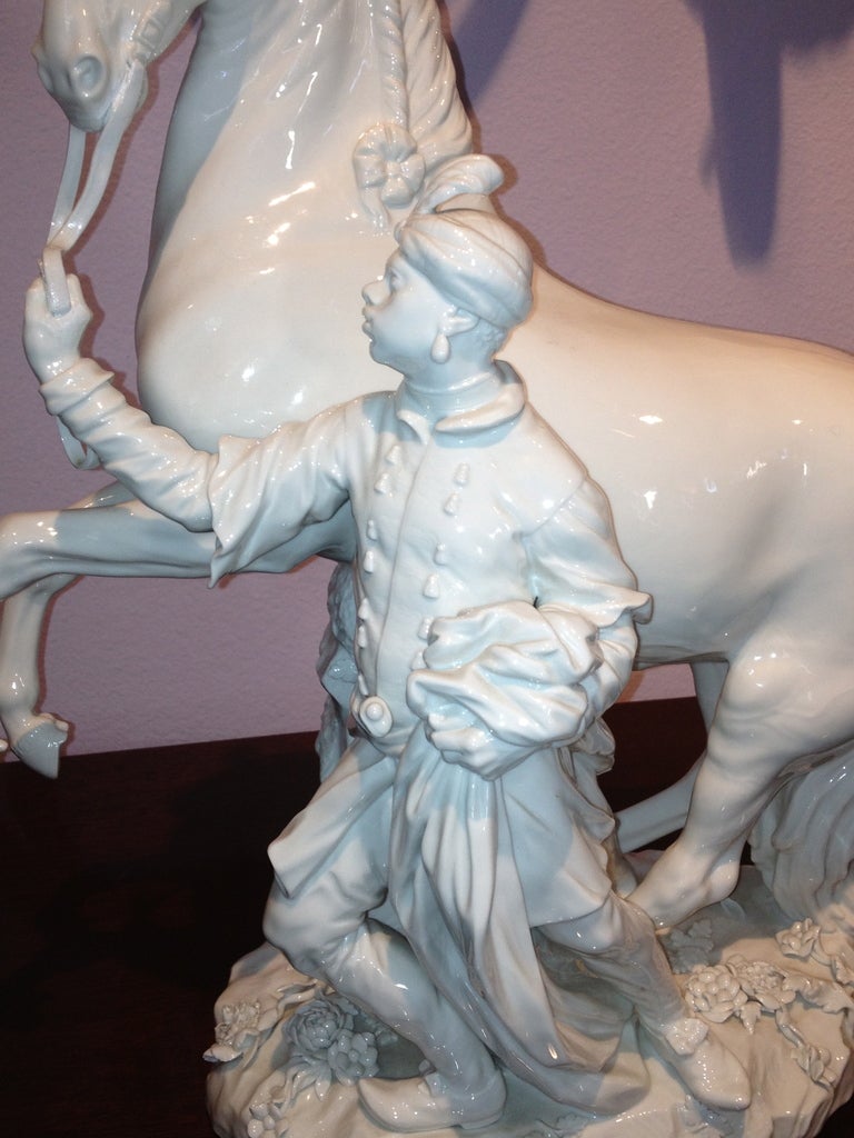 This Ex-large Meissen Blanc de Chine Statue is very well done. Flowers to the ground Attendant holding the reins of the spirited horse.  