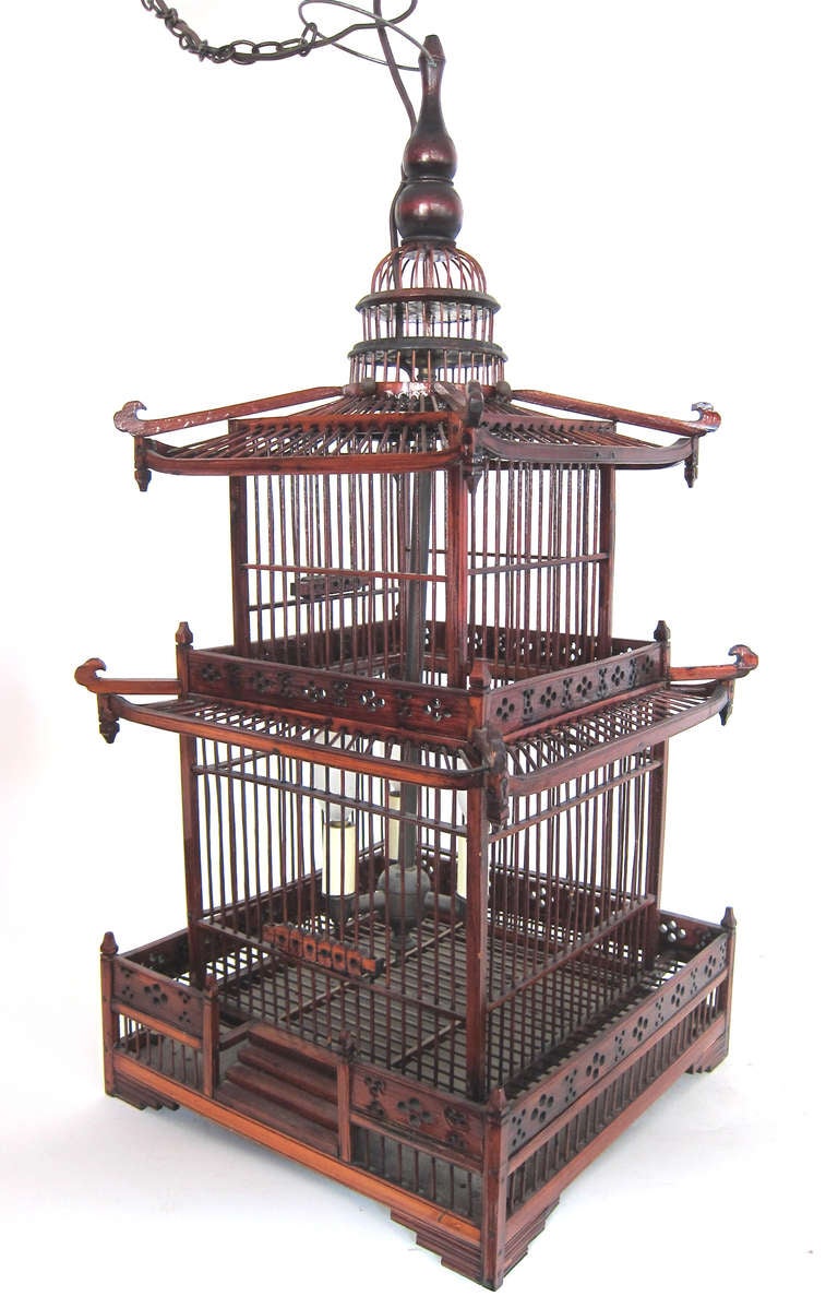 This hand made Chinese lacquered Pagoda shaped Lantern Chandelier has 2 levels and 3 lights with door.  Walkway design and dome wire top.