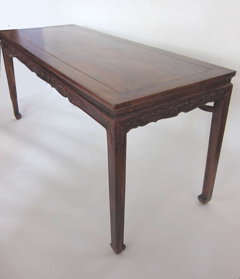 Beautifully carved and crafted Chinese scholar's painting table from the rare extinct tropical hardwood, Huanghauli. Masterfully crafted with mortise and tenon joinery; the legs are strengthened with the giant's arm brace. Having hand carved design