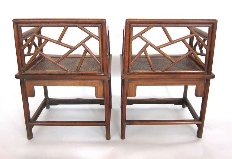 This pair of rare Chinese armchairs crafted with the very sought after Huanghuali (extinct) wood. The arm and back is in the cracked ice design and with rattan woven seats.