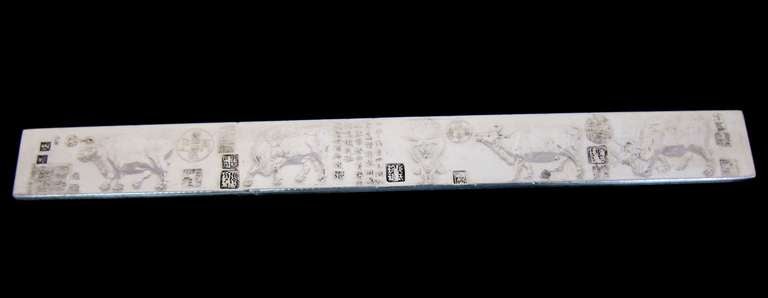 A set of 2 Chinese SILVER SCROLL WEIGHTS each rectangular form. One having relief decoration of oxen and the other tigers, each with inscriptions and multiple seals, silver standard mark stamped to the reverse. 9” long, Old Calligraphy characters