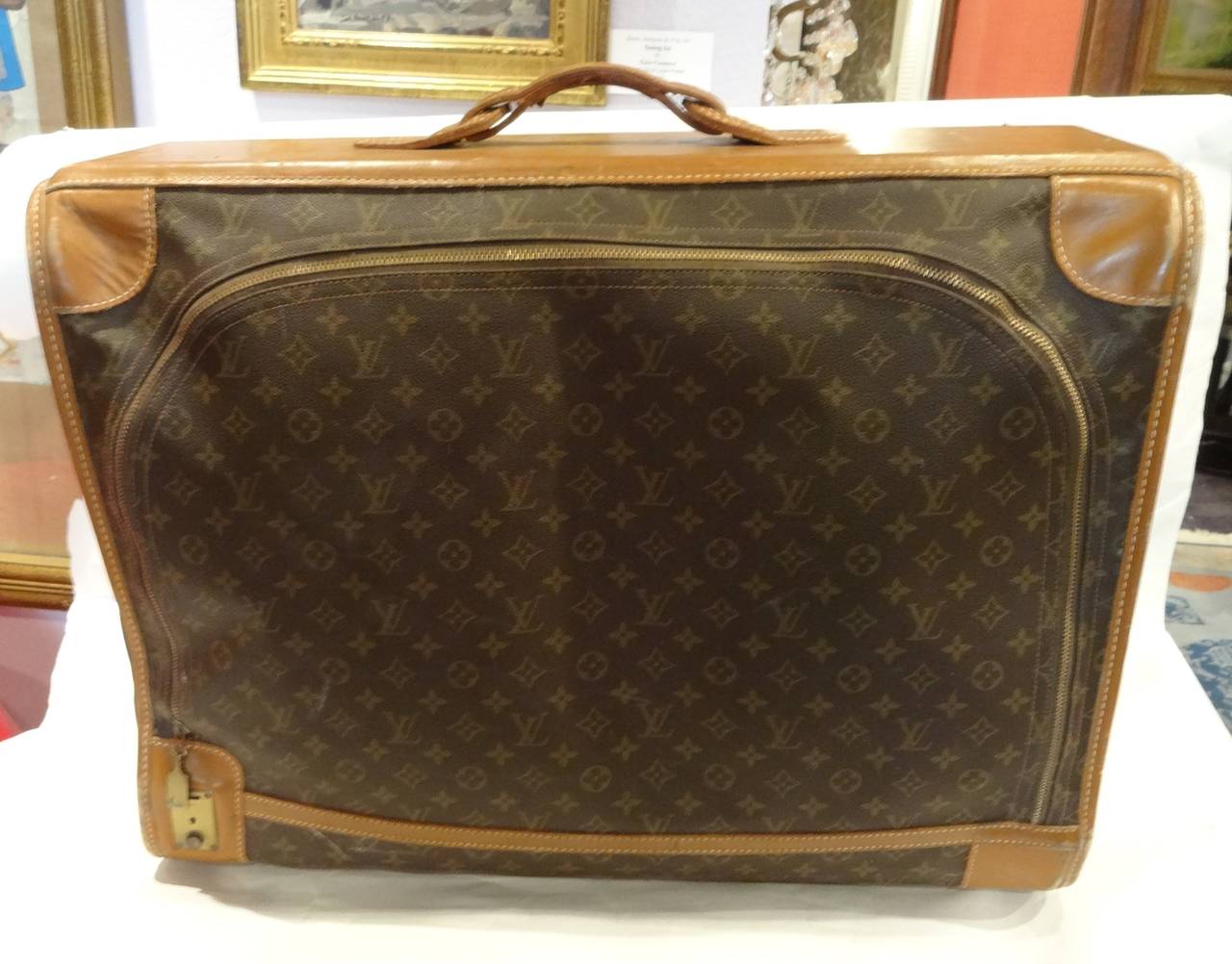 A vintage Louis Vuitton leather monogrammed suitcase/luggage with key