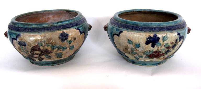A pair of Qing Dynasty ceramic planters decorated with floral and bird motifs.
With a beautiful painterly blue turquoise glaze.