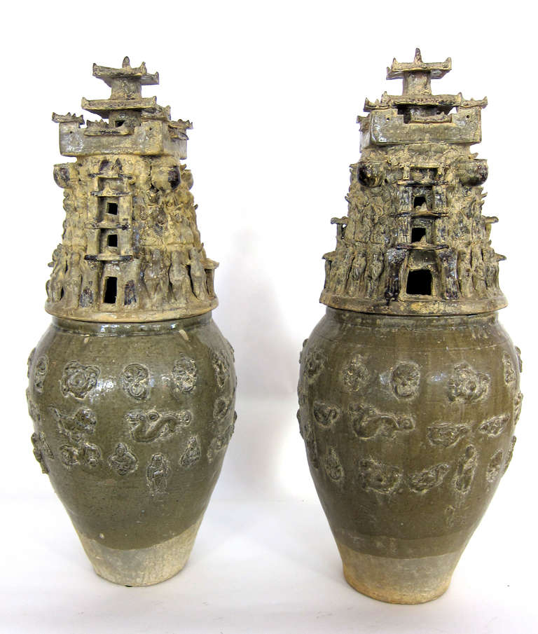 An unusual Pair of RARE Green glazed Eastern Han Dynasty Jars. The jar base is decorated with mystical animals and attendant figures. The tops are watch towers with attendants decorating the base entrance to the watchtowers. These ancient artifacts
