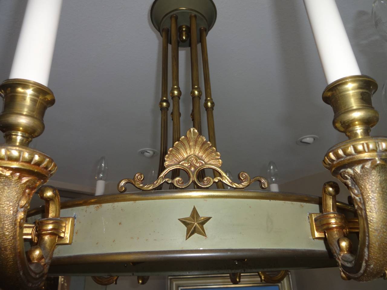 A French Empire style 12 light tole and gilt bronze chandelier
