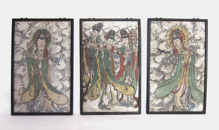 These beautifully painted frescos from the Ming Dynasty are made with Yangtze River mud. The paintings are depicting important Chinese deities,  with her attributes.
One is holding a flaming vessel ( long life ) with jewels in her headdress.  
One