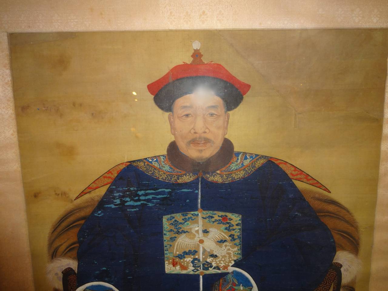 A framed Chinese ancestral portrait hand painted on silk of a high ranking member of the Imperial Court.