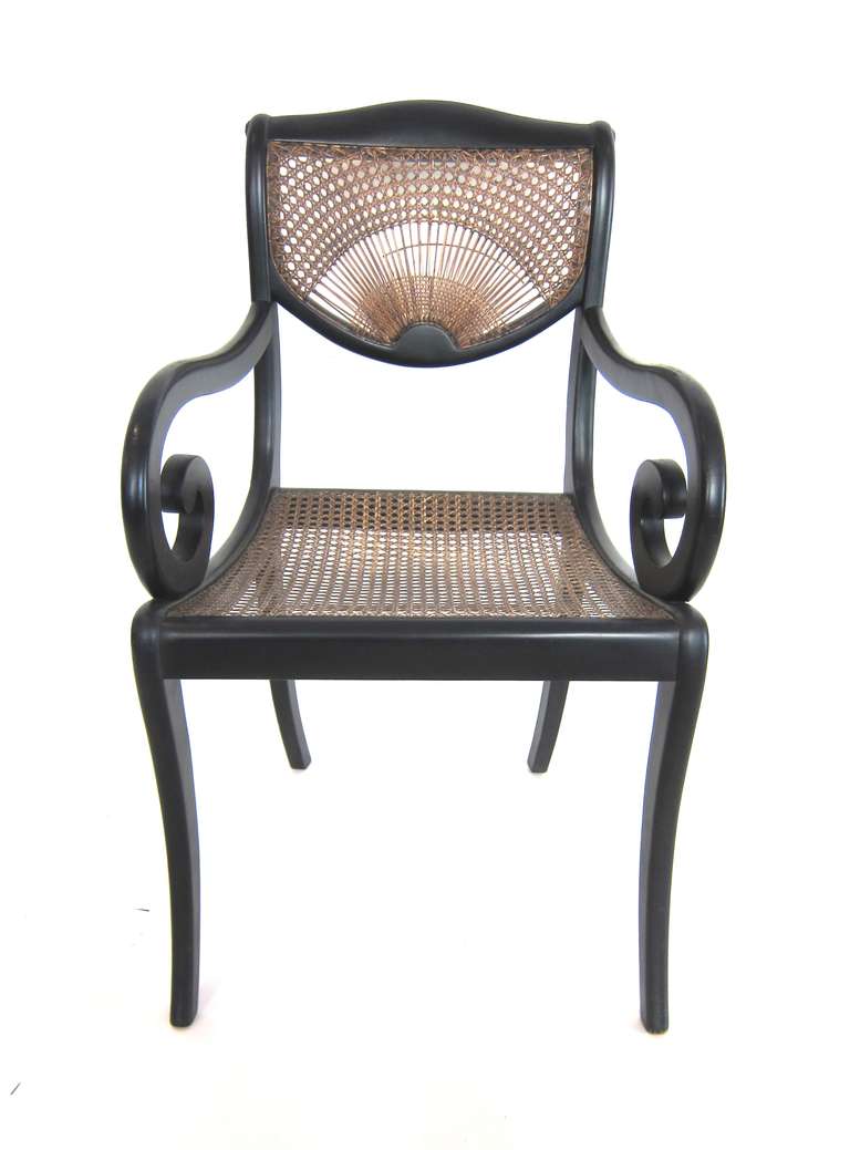 This Louis Philippe style Desk Armchair with a scroll/rounded arm black lacquer and caning to the seat and back. The back design in a fan. Light weight ease to move when getting up from a desk. Comfortable, a wonderful design