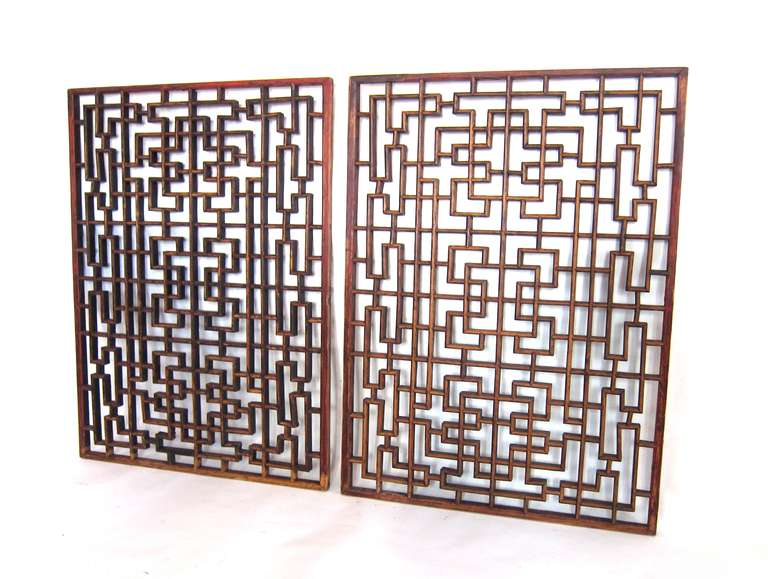 A pair of Qing Dynasty (circa 1820) window panels, crafted from jumu (Chinese northern elm) from the Shanxi province of China. Mortise and tenon joinery construction, no nails.