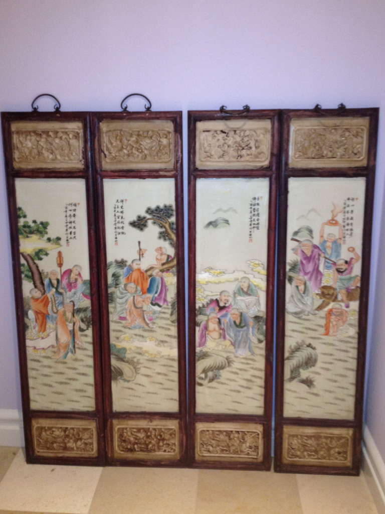 The Set of porcelain Wall Panels are hand painted with lo han Buddhas & scholars, etc. having cinnabar panels inset at the top and bottom of the wooden frames, also having hand made handles of iron (Below....Size of each includes hangers)  