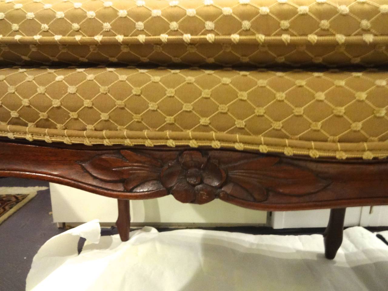 A Louis XV style carved walnut wood bench with six legs recently upholstered in gold fabric.