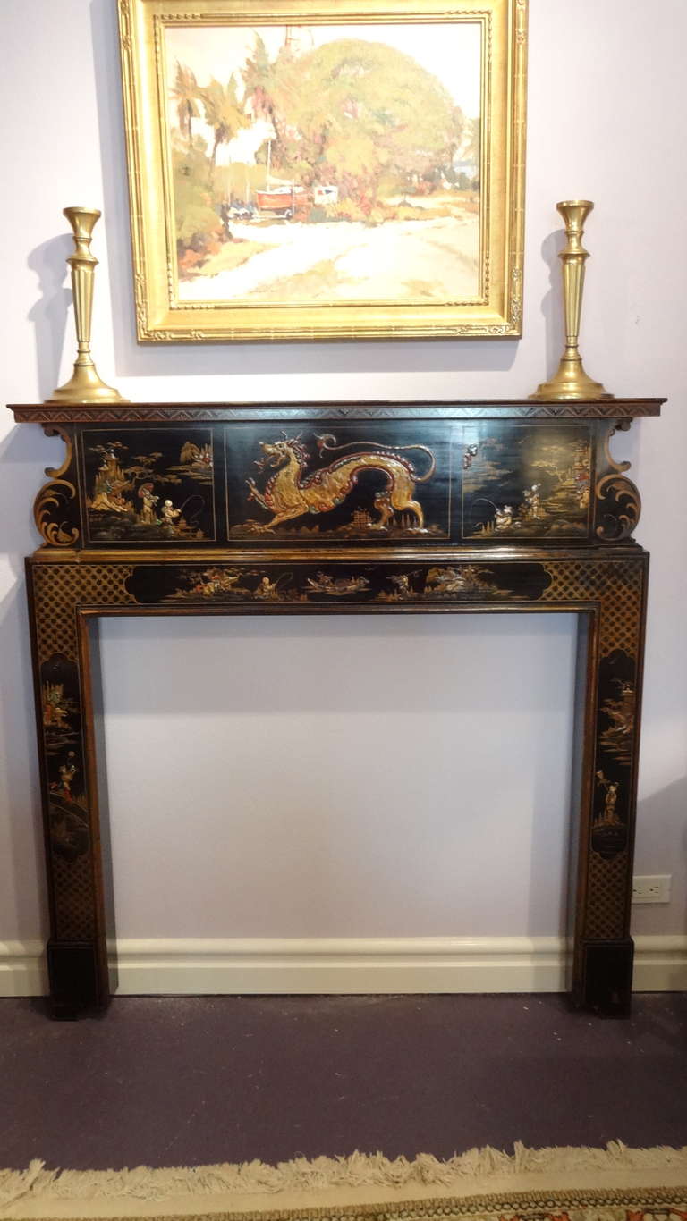 Wonderful black lacquered, gilt and hand painted in the Chippendale style Fireplace Surround/Mantel Having a DRAGON centered in the middle below the mantel and landscape scenery also hand painted to the sides.