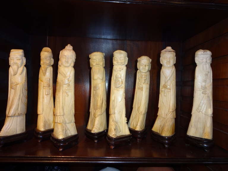 This set of Eight (8) Immortals Statues are hand carved from Bone and where made in China in the 20's.  These are from a collectors estate.  Hand carved all around.  Each on a rosewood stand triangle shape at the bottom.  kindly done