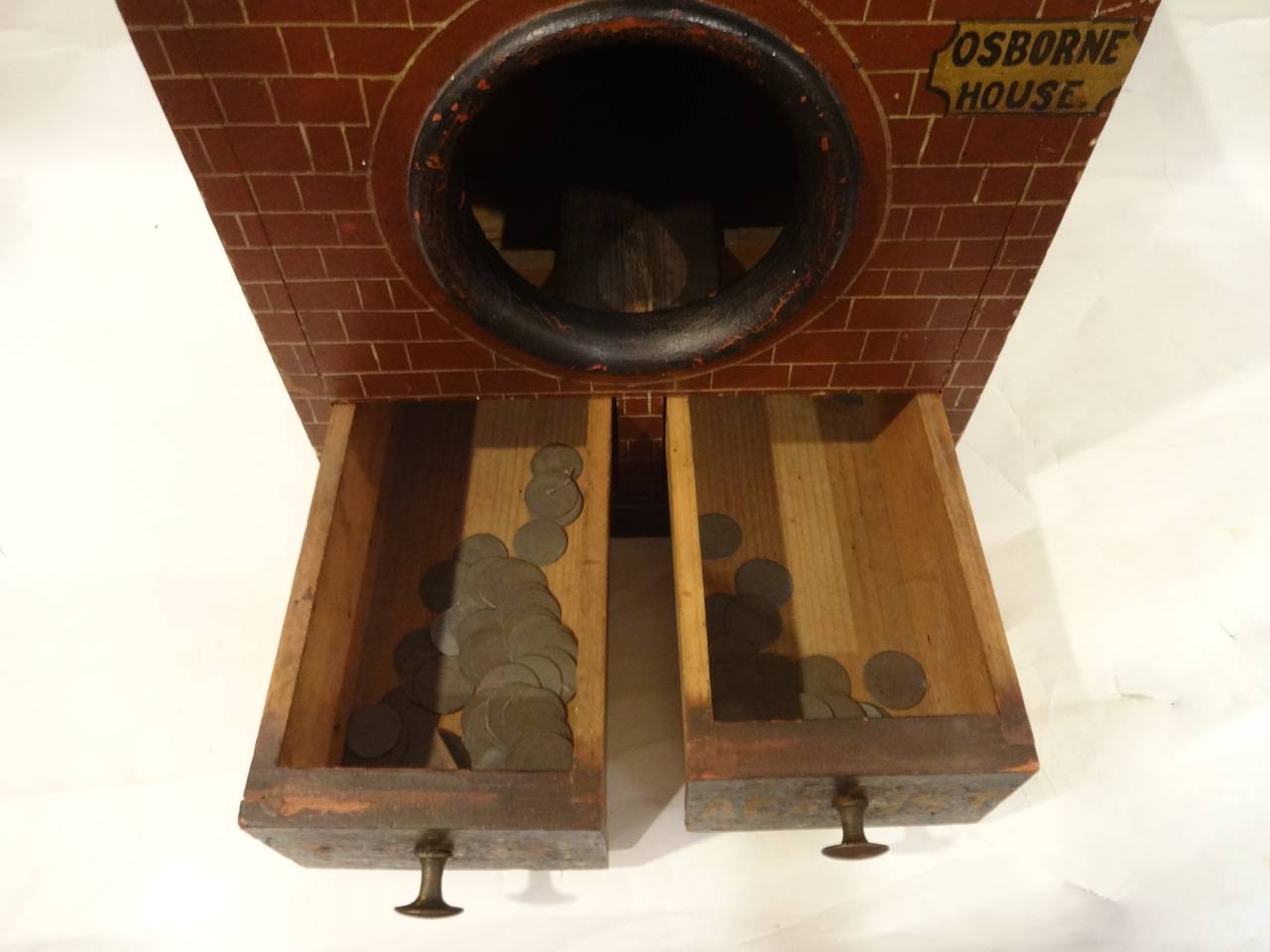An English Victorian wooden ballot box. The red brick, windows, doors, 