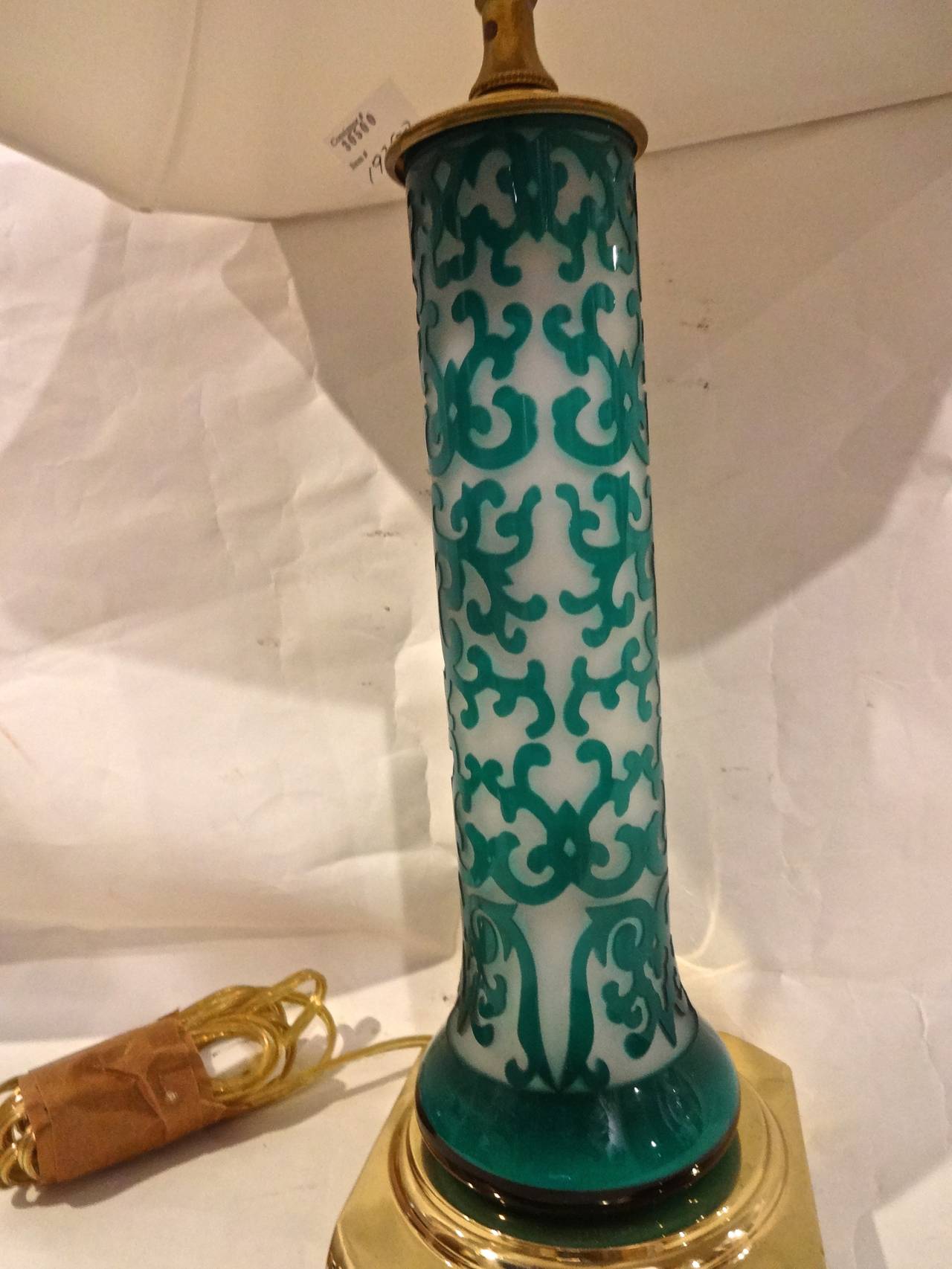 A pair of Chinese Peking glass boudoir lamps, white with aqua scrollwork overlay on brass base.