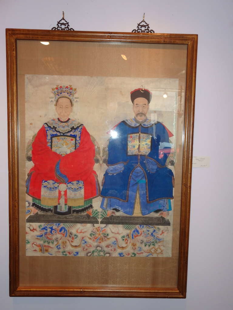 Well painted of a couple (the badge on the front of his dress is a ranking badge for a Civil Official (The Ming Dynasty instituted a system of rankinsignia for court officals using birds and animals to represent each level within the bureaucracy.