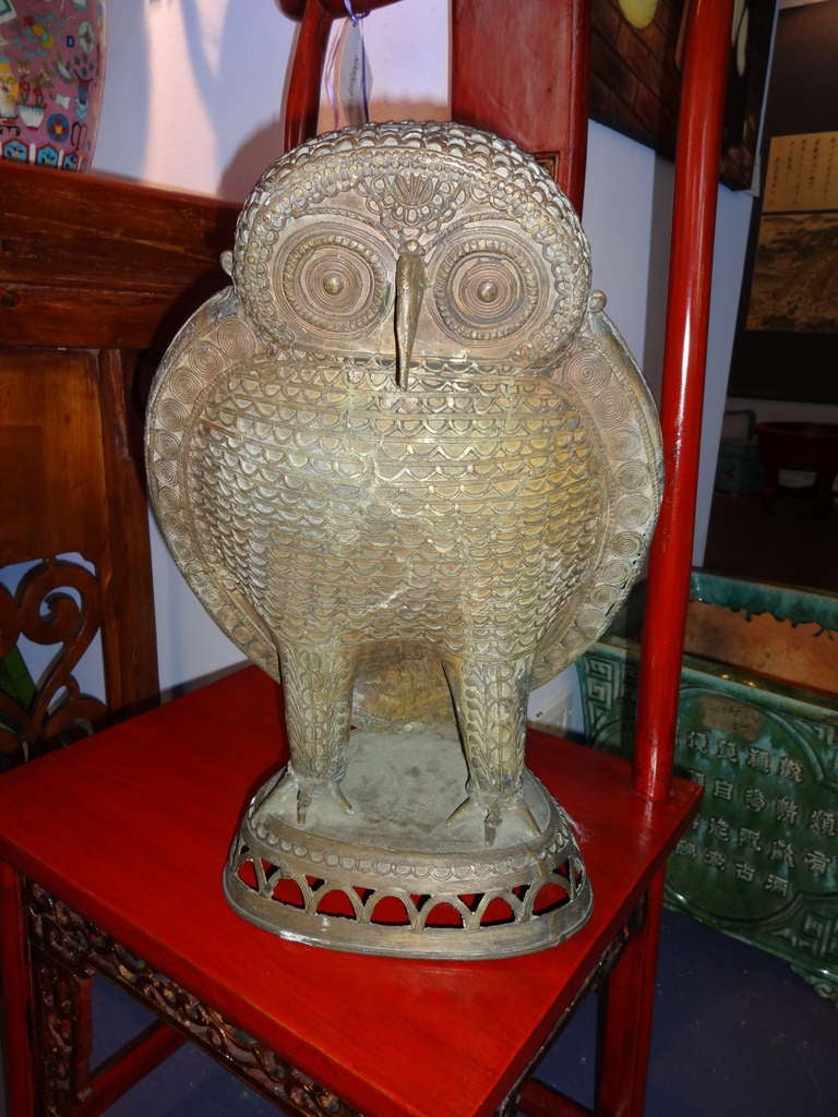 This bronze Owl hand made is from the Bastar Region of India, yes it is an antique.  These people would place a fresh flower between the legs of the owl for good luck.  This is Indian Tribal Art Standing on a triangle base overlad bronze in a