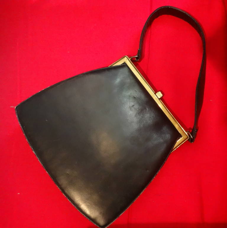 A black leather purse with turquoise leather interior, leather handle and metal clasp, stamped inside: 