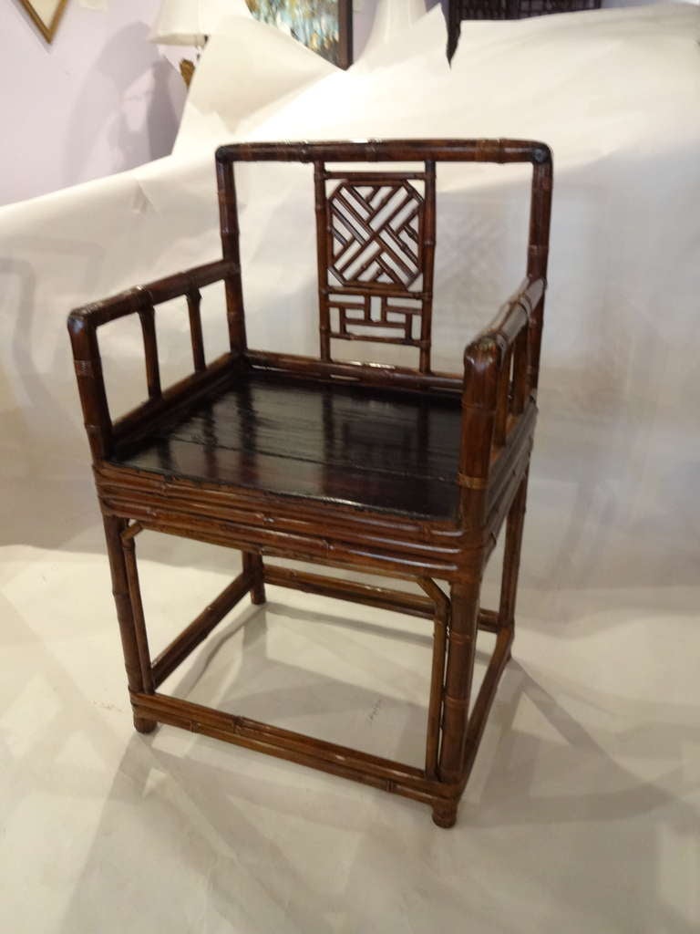 This pair of 18th century Chinese bamboo arm chairs have a black lacquered seat.  The bamboo is 