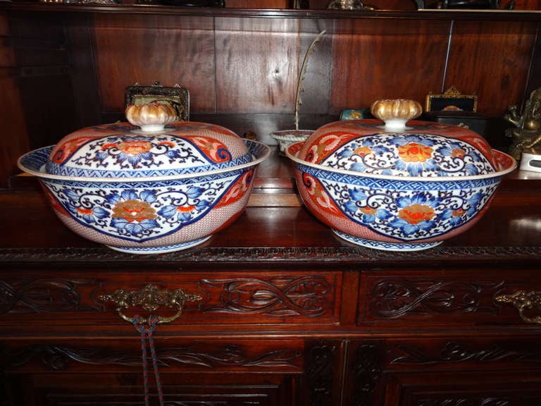 This Pair of Imari Soup Tureens/Containers with original lids are a pair in reverse, rust red dominates one and blue the other.  Or course hand painted on porcelain containers having a gilt open pierce work to the ARTICOKE Finial with gold design
