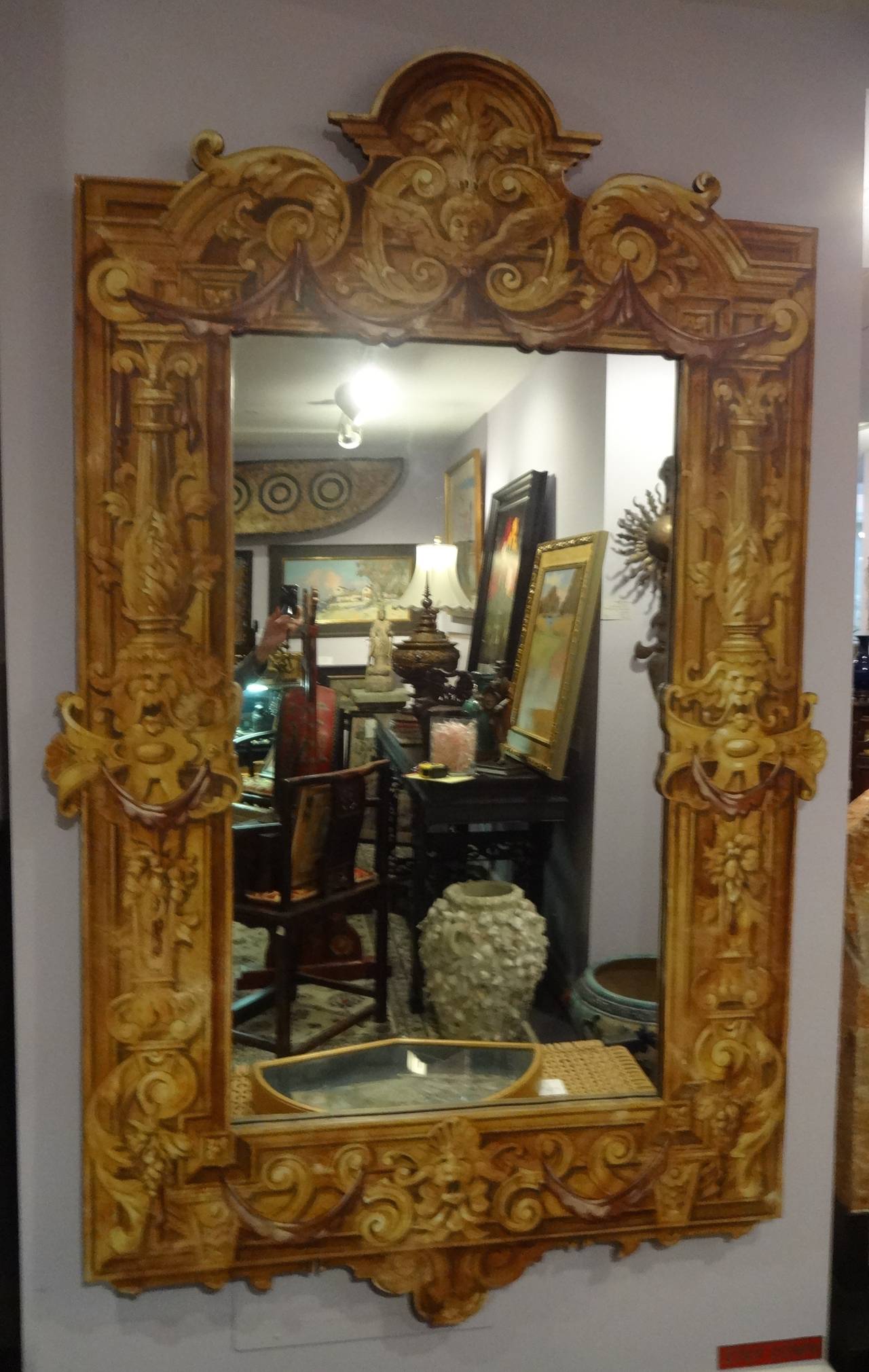 A Patina trompe l'oeil hand painted carved wood mirror in sepia tones 