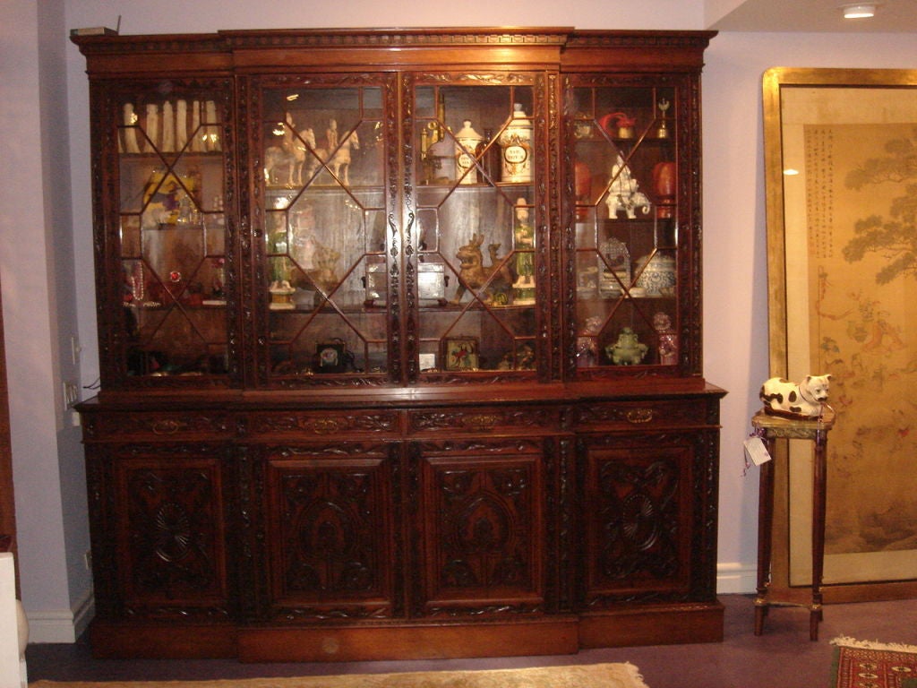 English Chippendate Revival Breakfront/Bookcase (Breaks down into 9 pieces)  Mahogany Handcarved original glass, original finish. Inside wooden slats for adjustable shelves A beautiful example, in the Chippendale design book.