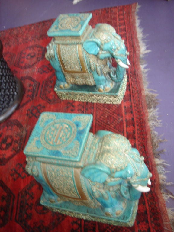 These Well done Ceramic Elephant Stands are well carved and painted are from Vietnam and having a seal ingraved to the base. The turquiose glaze has gold flakes with white trim.  THE BEST I HAVE EVERY SEEN! There is a glass top which can go with