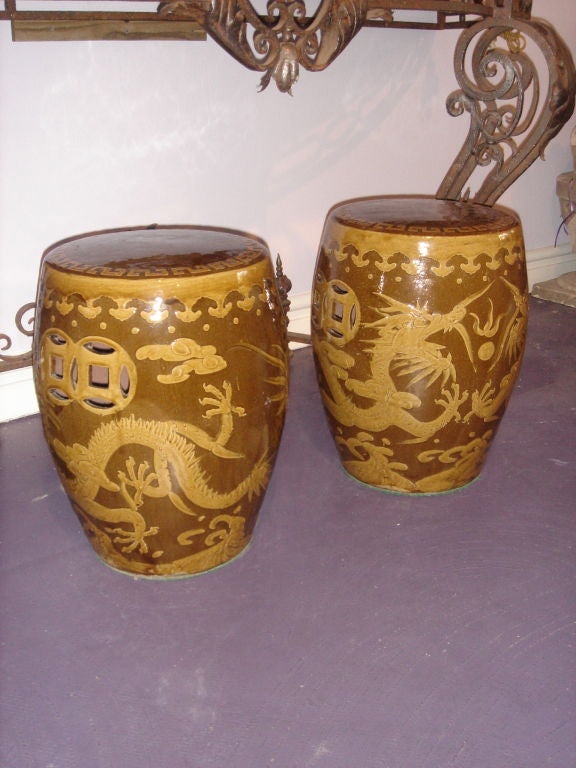Pair of Ceramic DRAGON Chinese GARDEN STOOLS having the dragon, pearl, fire and cloud hand carved and painted mustard yellow with open ends 