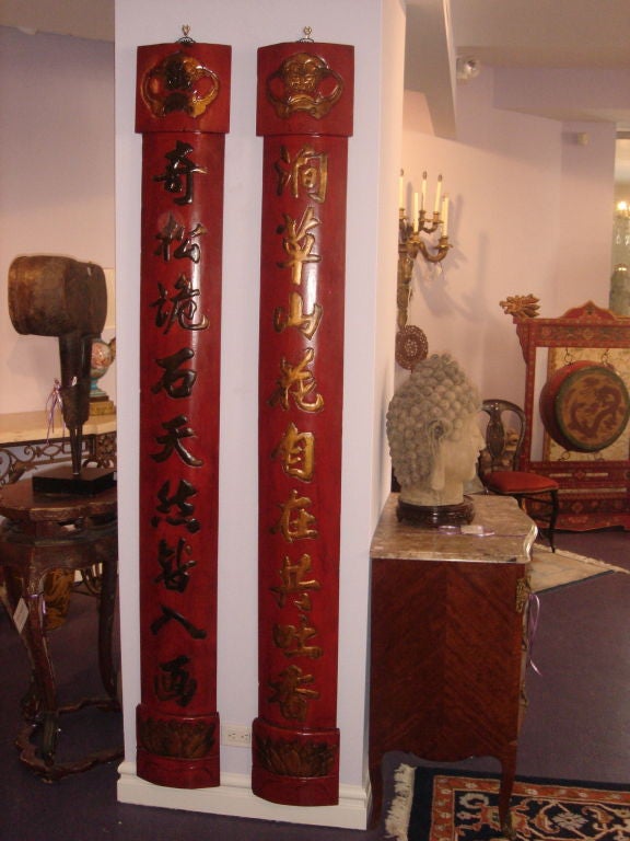 A Pair of Chinese Red Lacquered Poetry Signs hand made with calligraphy in black lacquer and gold leaf, leaves to the bottom of each, dragon face to the tops. The calligraphy interpretation is about happy being with natural, waterfalls and