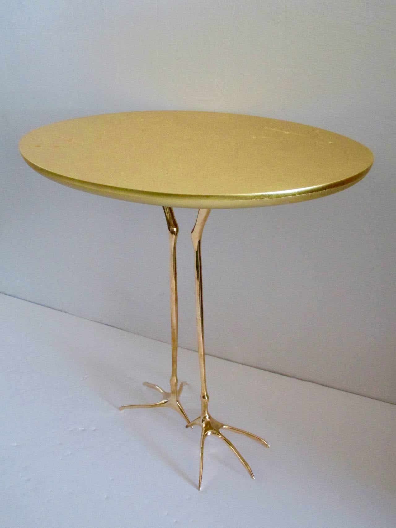 Surrealist table by Méret Oppenheim with polished cast bronze.
Bird's legs and top in 24-carat gold leaf.