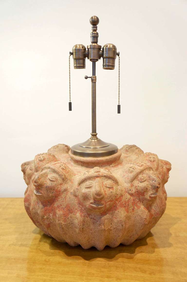 Clay pottery lamp with eight molded faces. New antiqued brass fittings and double cluster ... brown silk twist cord. In the manner of Toltec. The Toltec culture is an archaeological Mesoamerican culture that dominated a state centered in Tula.