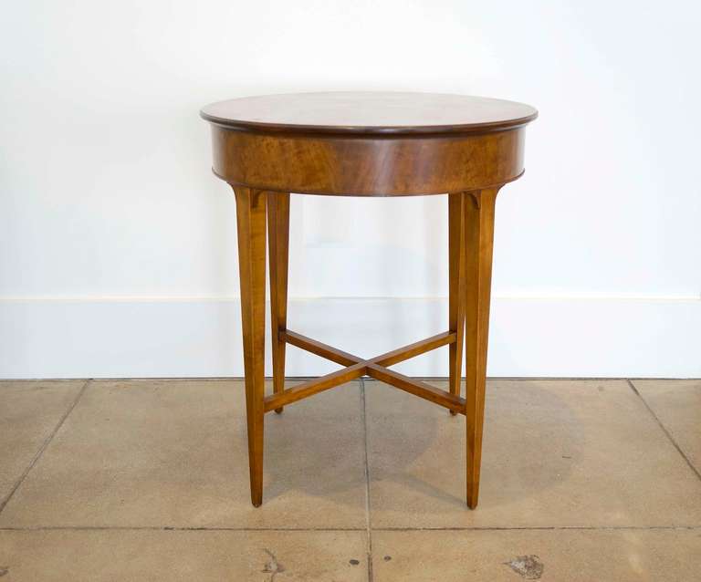 Figured mahogany occasional table. Solid top, legs and strechers with a bent wood veneer skirt.