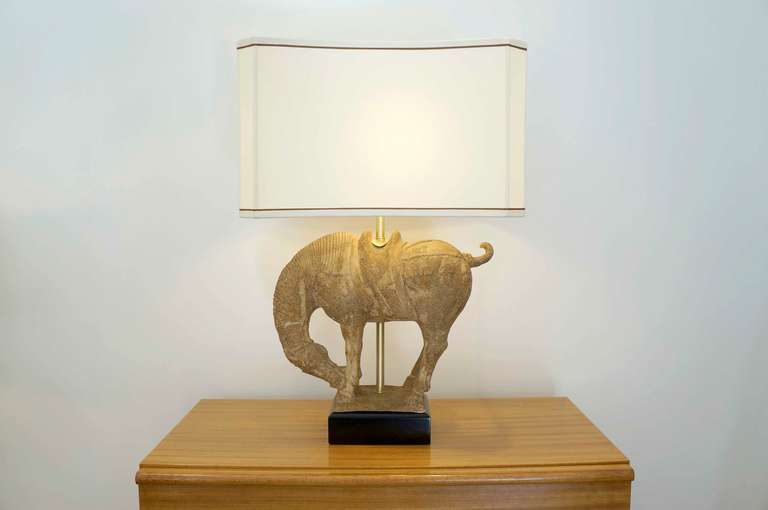 Clay horse table lamp in the "forward ... down and out position". Adorned with a custom linen shade, bowed and chamfered! Shade included. Restored brass fittings,professionally rewired.
Horse dimensions alone are as follows:
H 16 x L 20 x