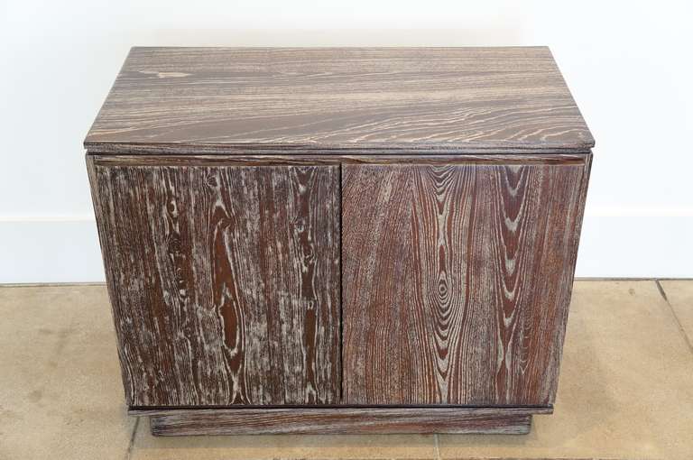 Solid two door cerused oak cabinet with a deep rich brown ceruze and cream graining.<br />
The doors are supported by dovetail spine stiffeners and brass fittings.<br />
Thoughtful steeped detailing resulting in subtle shadow lines!