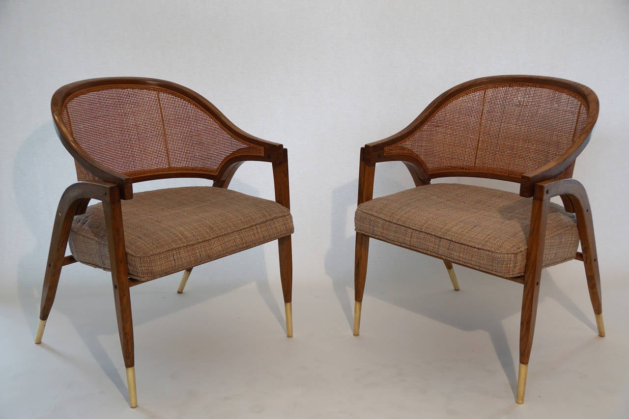Model # 5480 cane back chair is suspended in laminated ash cradles with tall brass shoes and brass vertical supports. These chairs are equally useful for the living room, the game room or the dining room. The chairs were delivered to Los Angeles by