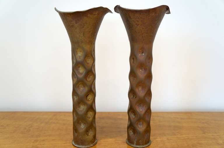 Rare Pair of Dirk Van Erp Shell Casing Vases with original patina. Surface treatments range from irregular grids of hammer marks to masses of warty bumps. Markings include manufacturer and date W.N.Y 8-1904 
