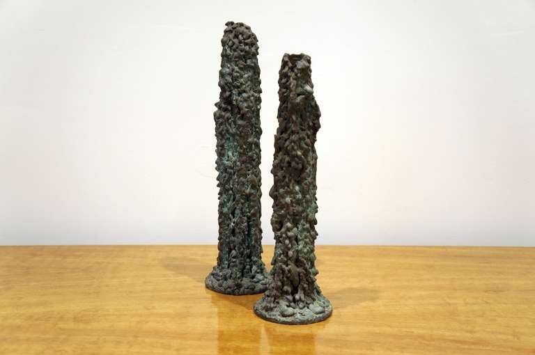 Pair of bronze candle sticks by H.L.Pastorius. Each one is unique to itself both in size and complexion. Signature to both.