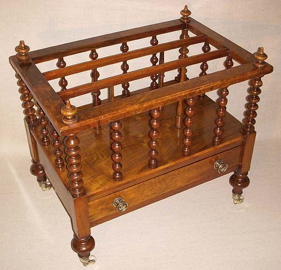 Mahogany Bobbin Turned Canterbury Divided into Three Compartments above One Drawer and Raised on Four Legs with Casters.  England, 19th Century.<br />
<br />
23 inches wide x 15 inches deep x 20 inches high
