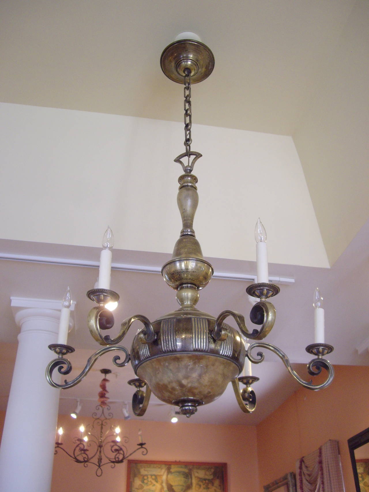 Heavy worn brass with nice patina 1920s six-light chandelier with alabaster shade.
Height with chain is 63.50 inches from ceiling to bottom of chandelier. Chain is about 22-24 inches.