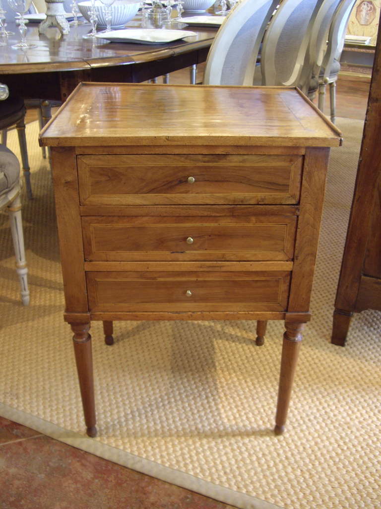 Inlaid 19th century Louis XVI style walnut three drawer side table. Beautiful patina.