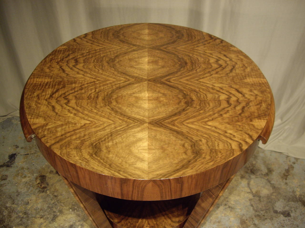 Beautiful veneered round Art Deco table with side slides that pull-out for drinks. Carefully restored and French polished. Would make a wonderful center hall table.